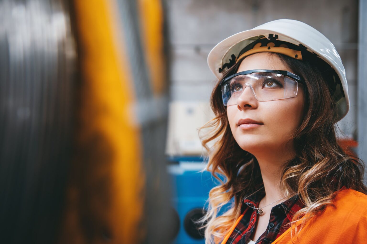 A PGT field technician on site in a hard hat and safety glasses